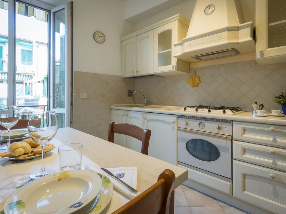 The fully equipped kitchen opens to the small balcony with the washing machine. 