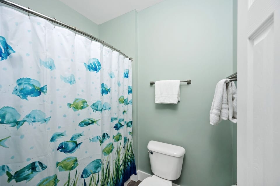 Master shower and toilet with door for privacy from bathroom sink and closet. 