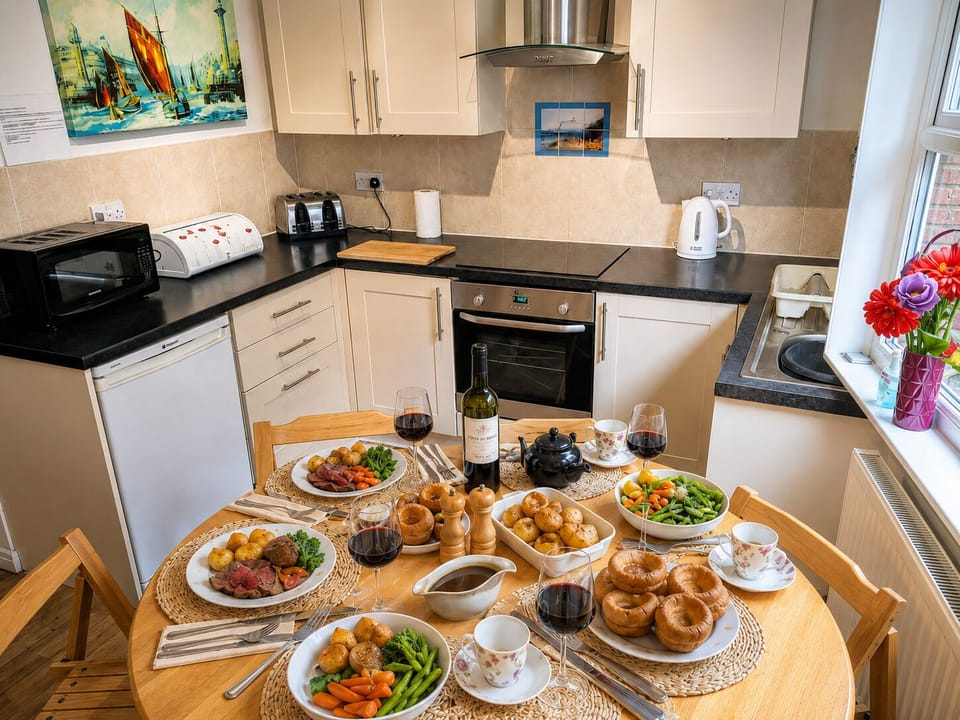 Bright kitchen and dining space with a well-equipped cooking area and table set 