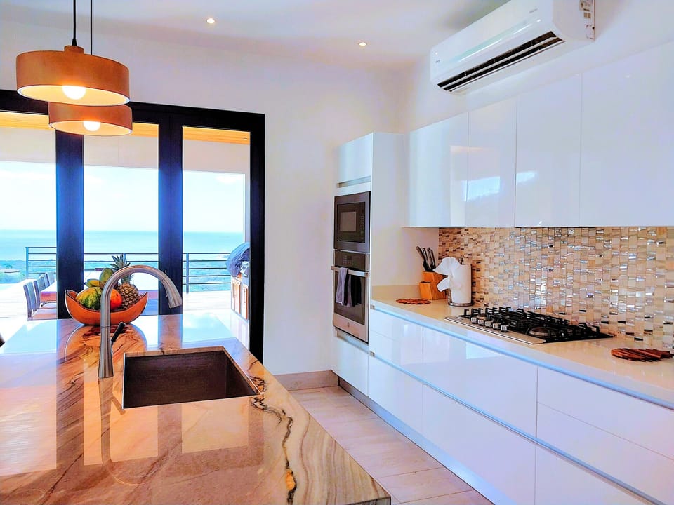 Cook with stunning Ocean Views! Chef kitchen with oven, dishwasher, gas stove and side-by-side fridge, right next to the outdoor BBQ Area