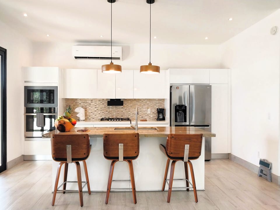 Chef kitchen with oven, dishwasher, gas stove and side-by-side fridge