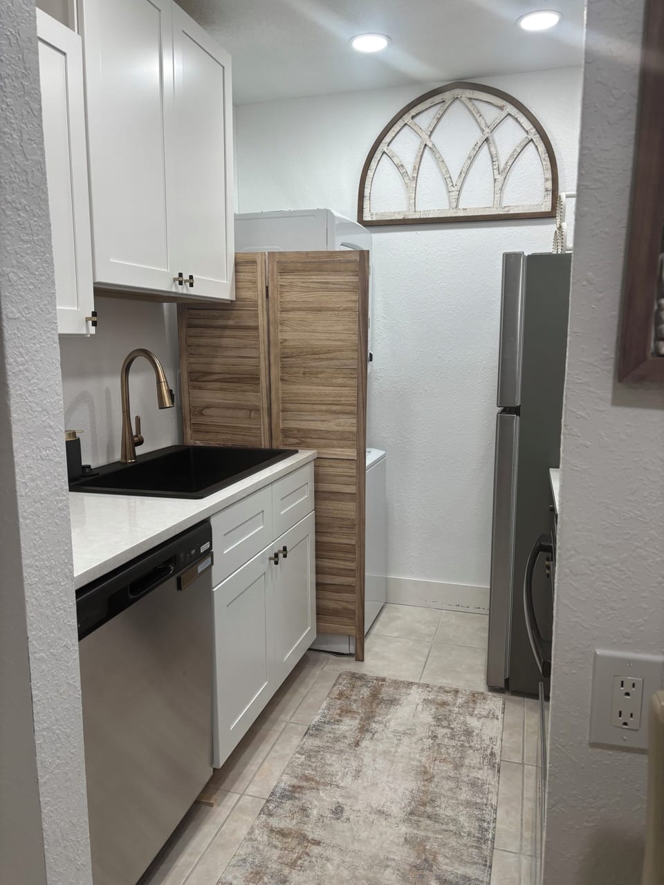 Full kitchen with full size stacked washer and dryer