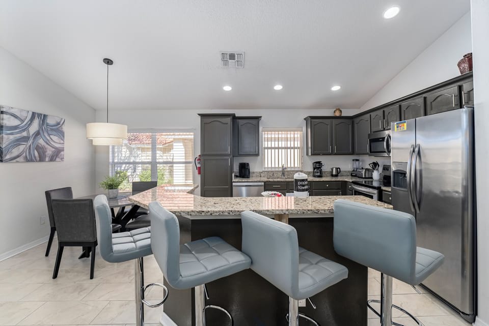 Kitchen view showing 4 barstools at the island.
