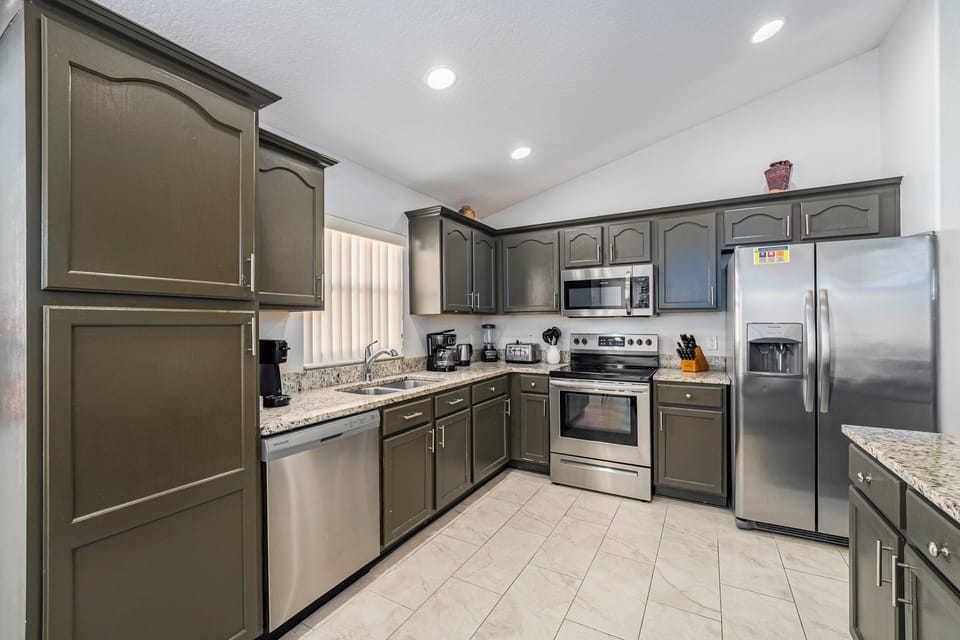 View of kitchen showing major appliances.