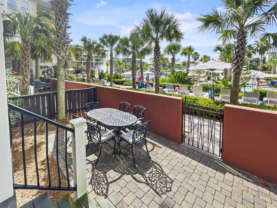 Furnished patio with a table, chairs, and umbrella