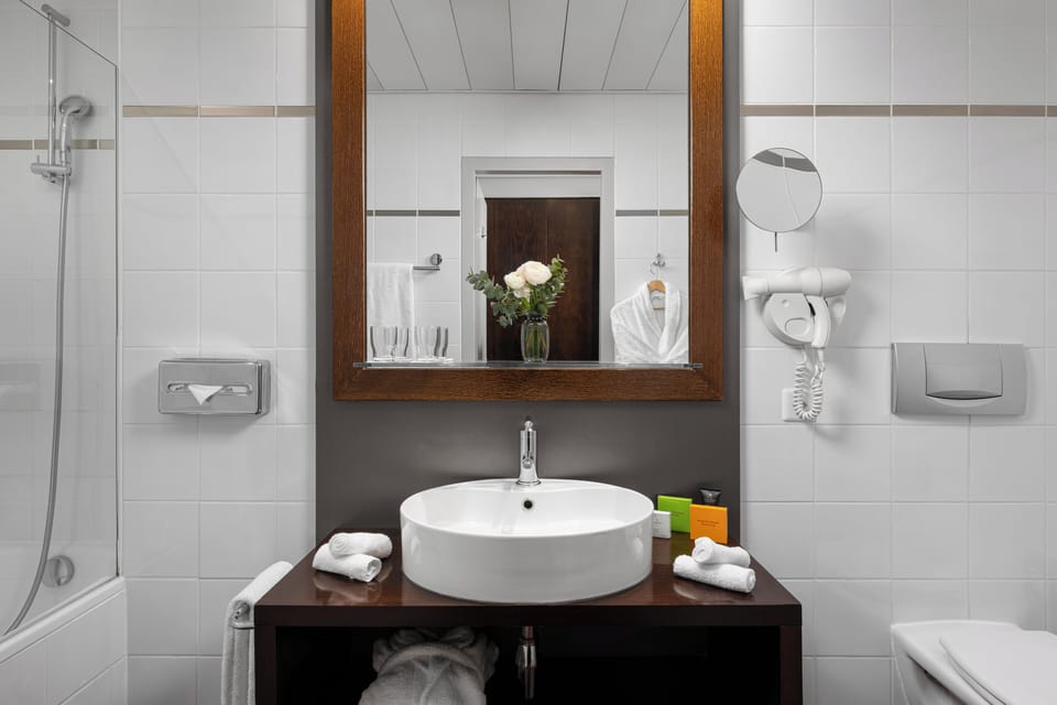 Bathtub, eco-friendly toiletries, hair dryer, towels