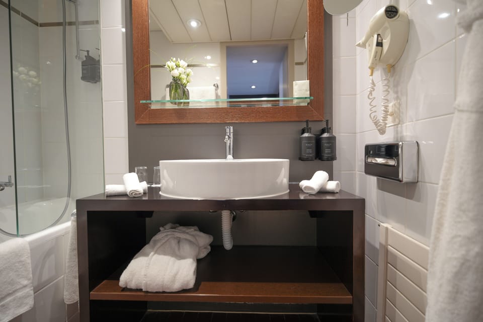 Bathtub, eco-friendly toiletries, hair dryer, towels