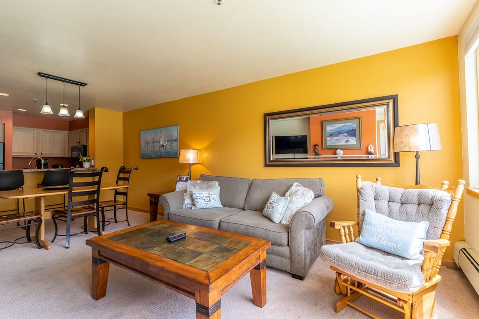 Relax in your bright, open-concept living space with comfortable seating and fully equipped kitchen perfect for your mountain getaway.