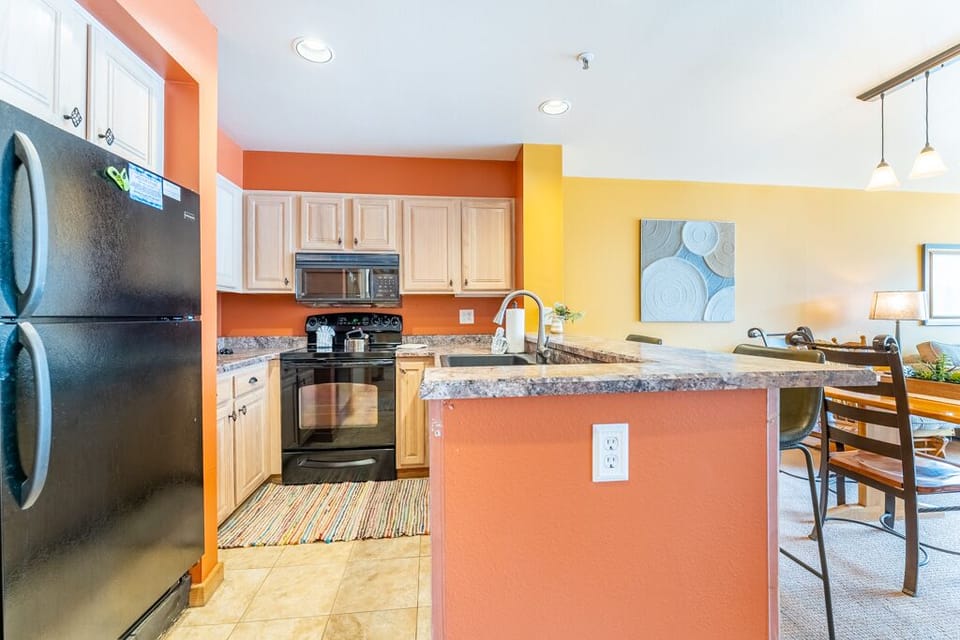 Your vibrant kitchen awaits with granite counters, full appliances, and cheerful colors that make cooking feel like pure joy.