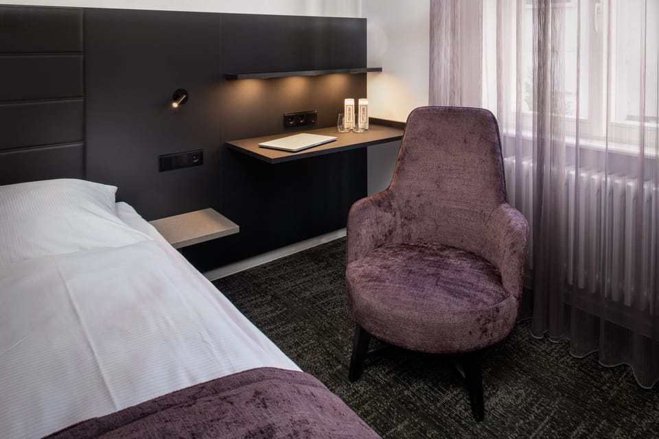 Hypo-allergenic bedding, desk, laptop workspace, blackout drapes