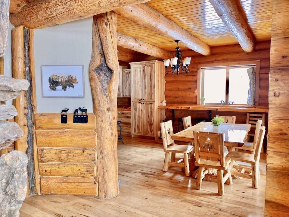 Dining area boasts a unique wood table along with plenty of seating along wall. 