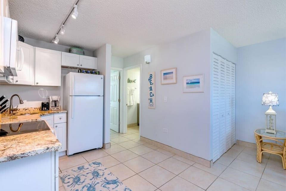 Kitchen with bathroom leading into the bedroom. 