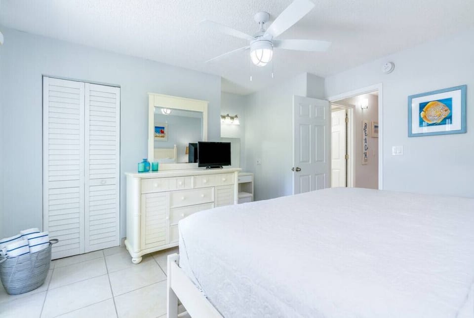 Bedroom with dresser, closet and makeup vanity.
