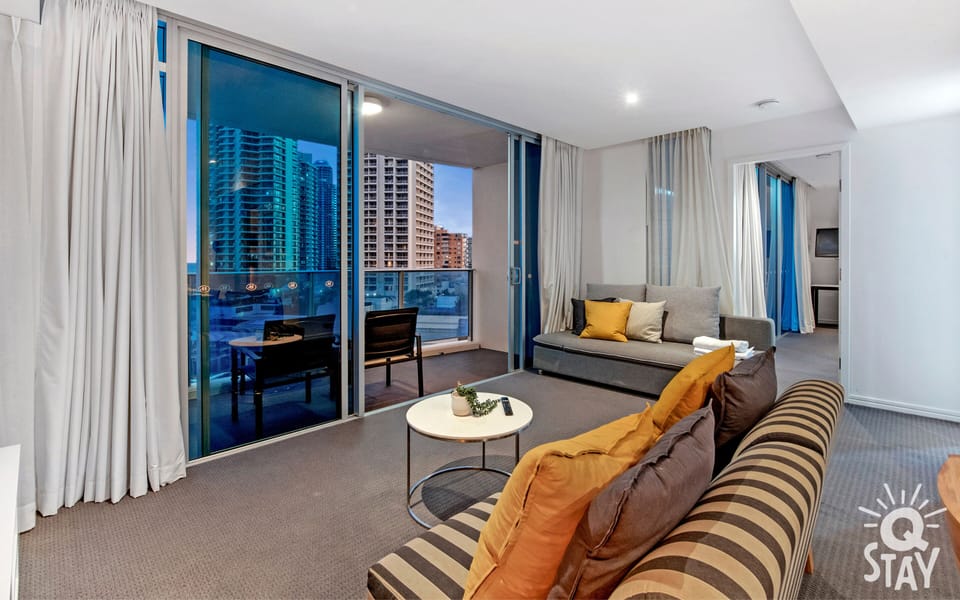 Cozy living room is right next to the balcony overlooking the ocean and the city