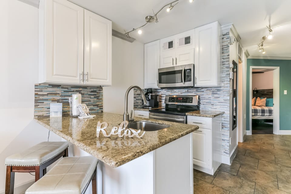 Kitchen with granite countertops and full size appliances.   Equipped with all the tools for a "home chef"!