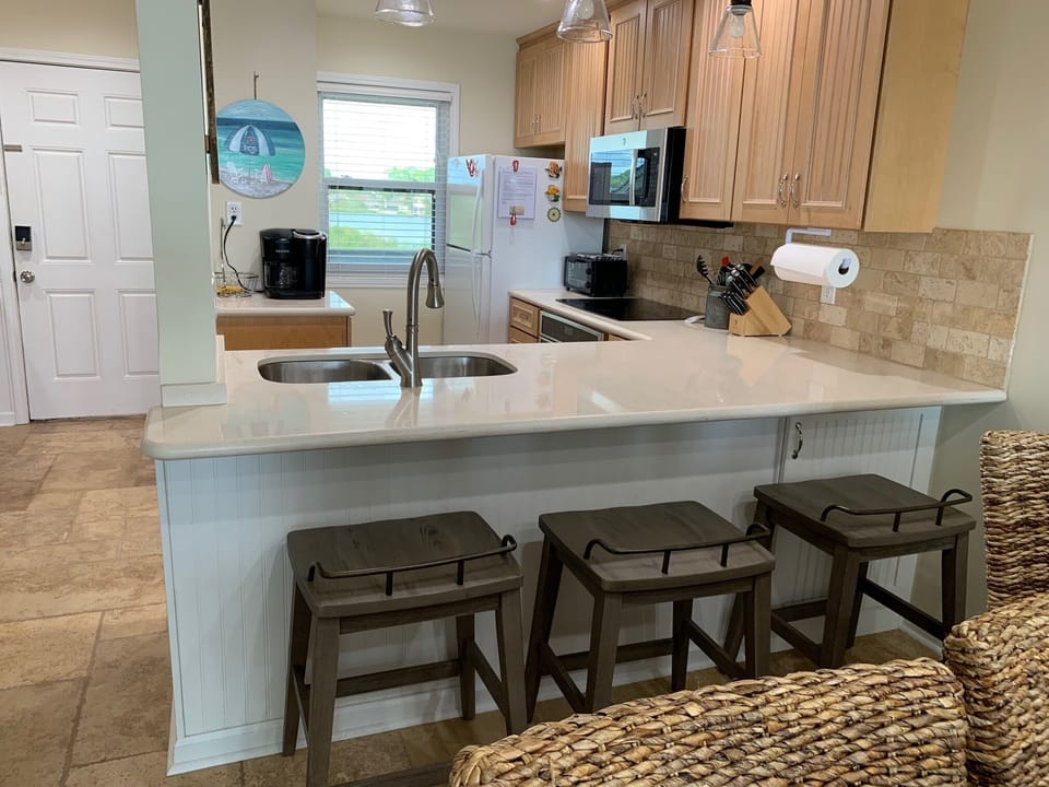 Kitchen with Bar Stools, Microwave, Toaster Oven and Keurig Duo