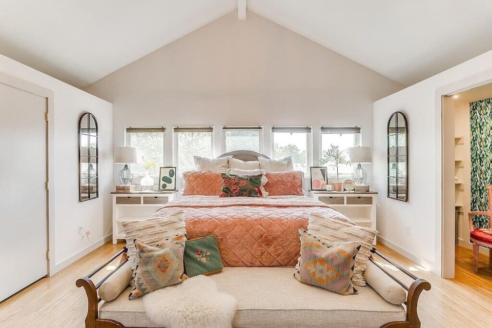 King bedroom with vaulted ceilings, layered linens, and calm Fort Worth retreat style.
