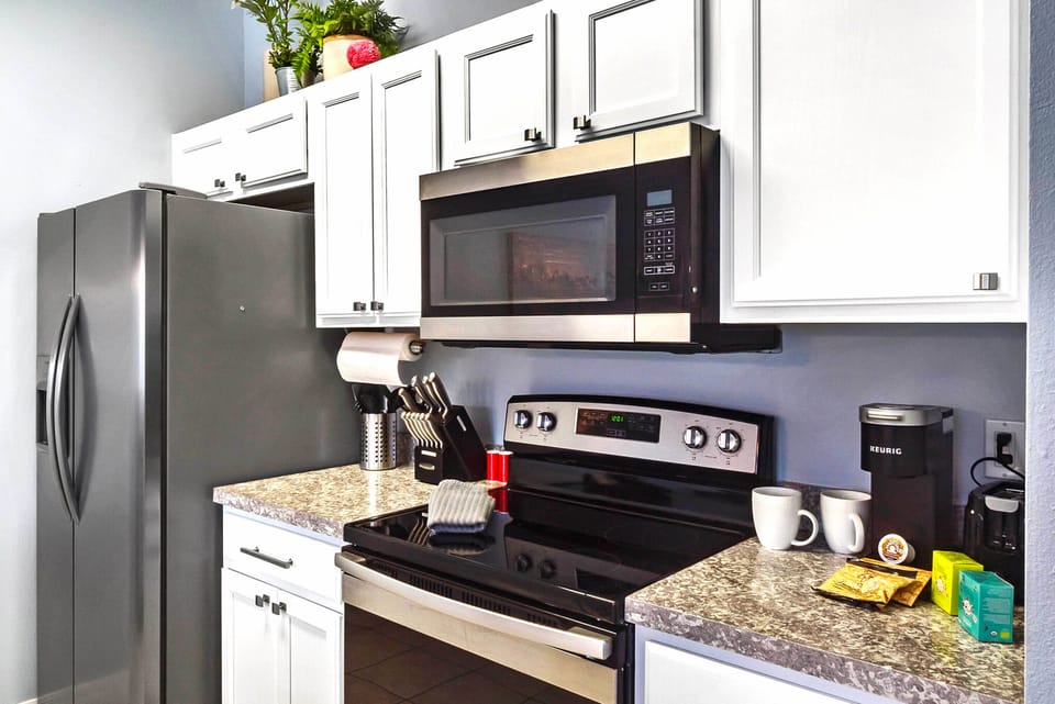 kitchen with Keurig coffee maker, regular coffee pot,  and tea kettle