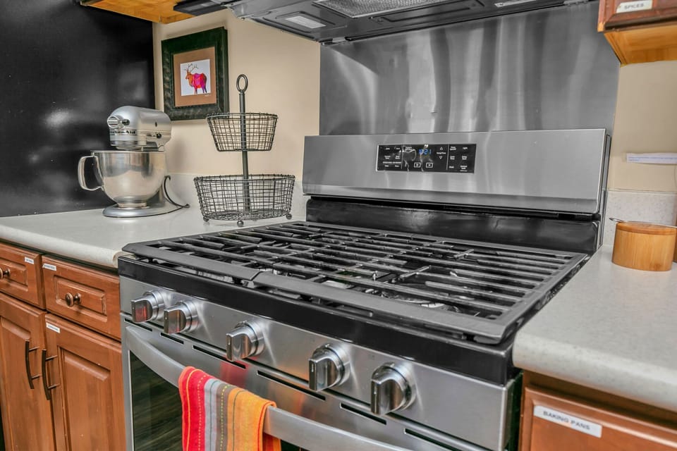 The gas stove, along with the other modern appliances, are stainless steel and easy to clean.