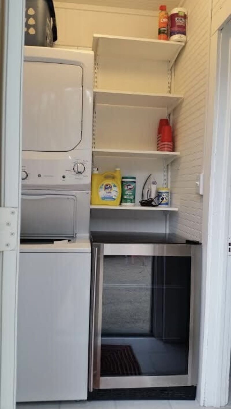 Stacked laundry and refrigerator located on the first floor off the kitchen