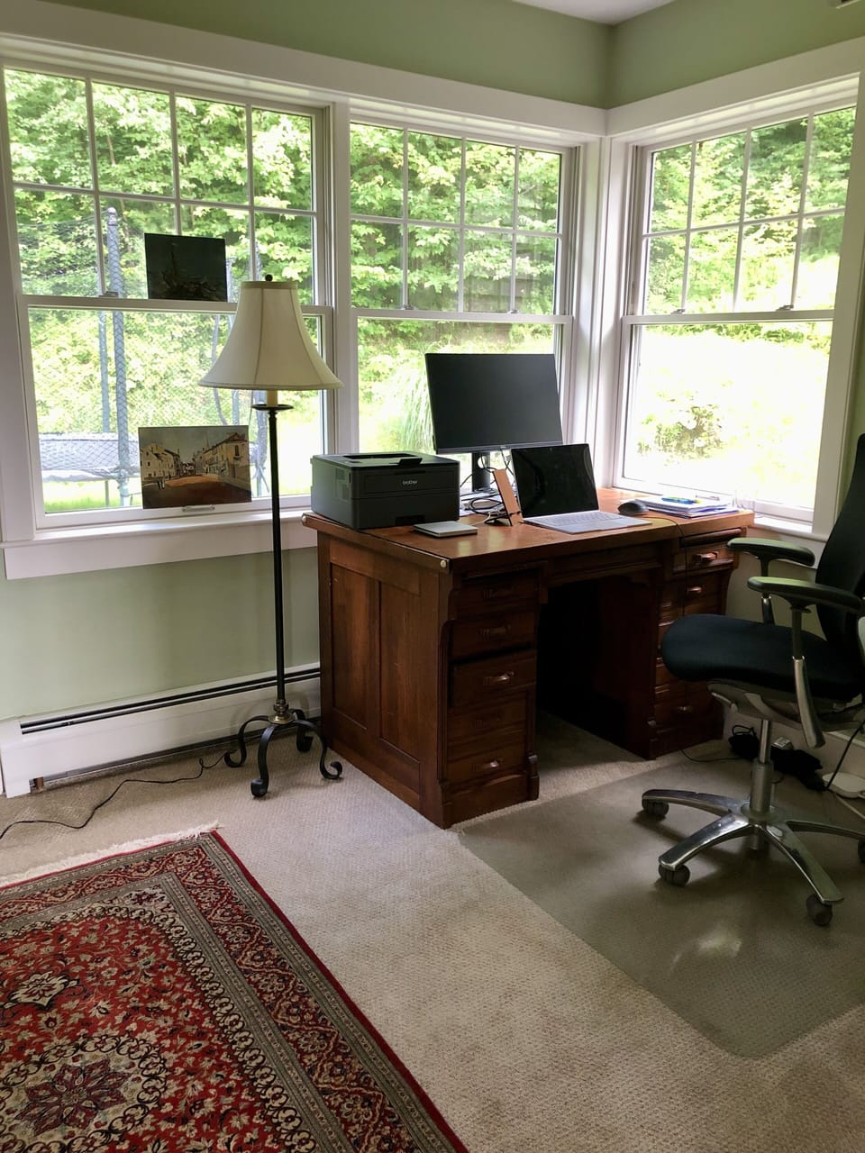 Office with desk, mouse and monitor on main floor.