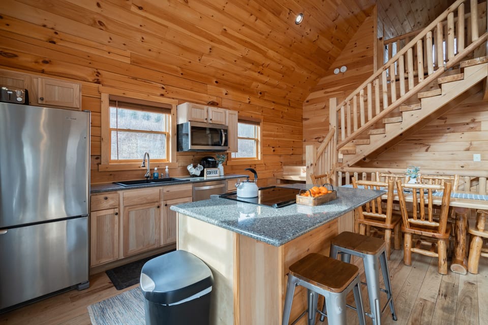 Fully equipped open kitchen, dining table, and island for extra seating