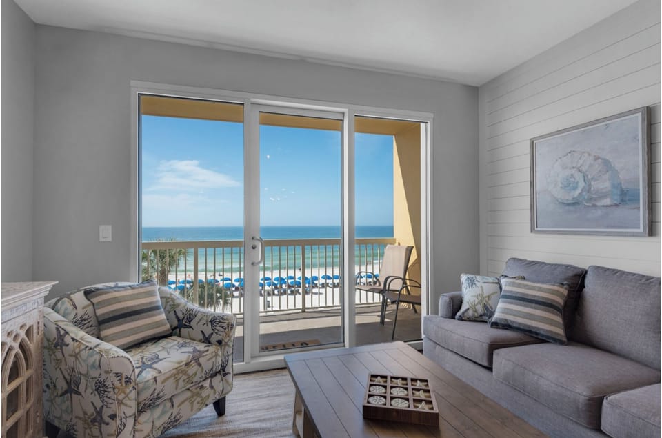 Unwind in your coastal living room where panoramic ocean views and gentle sea breezes create the perfect beachfront retreat.