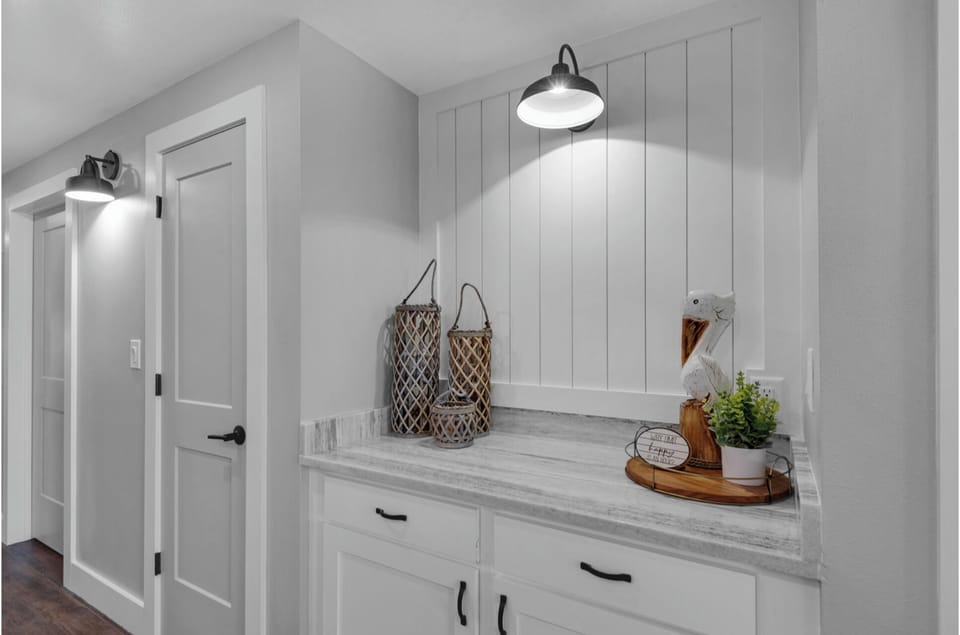 Your kitchen's butler's pantry offers beautiful white cabinetry and elegant marble countertops for meal prep and storage.