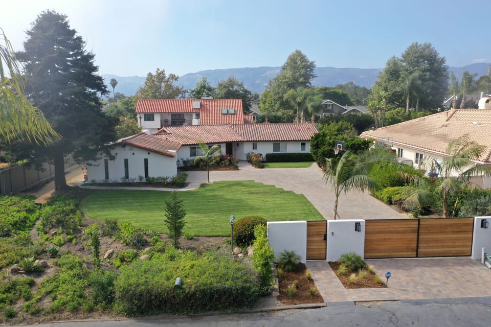 Gated entry, large lawn, basketball playing area.
