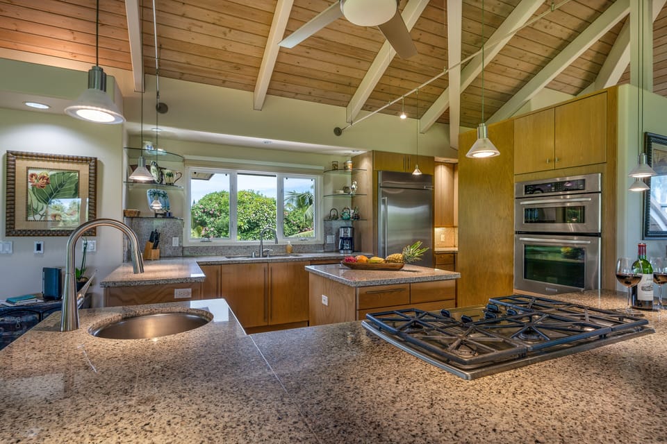 Propane cooktop, single sink in 2nd granite top island with bar stools
