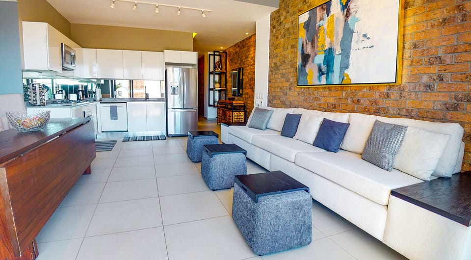 Spacious open floorplan with views to the balcony featuring city/ocean views