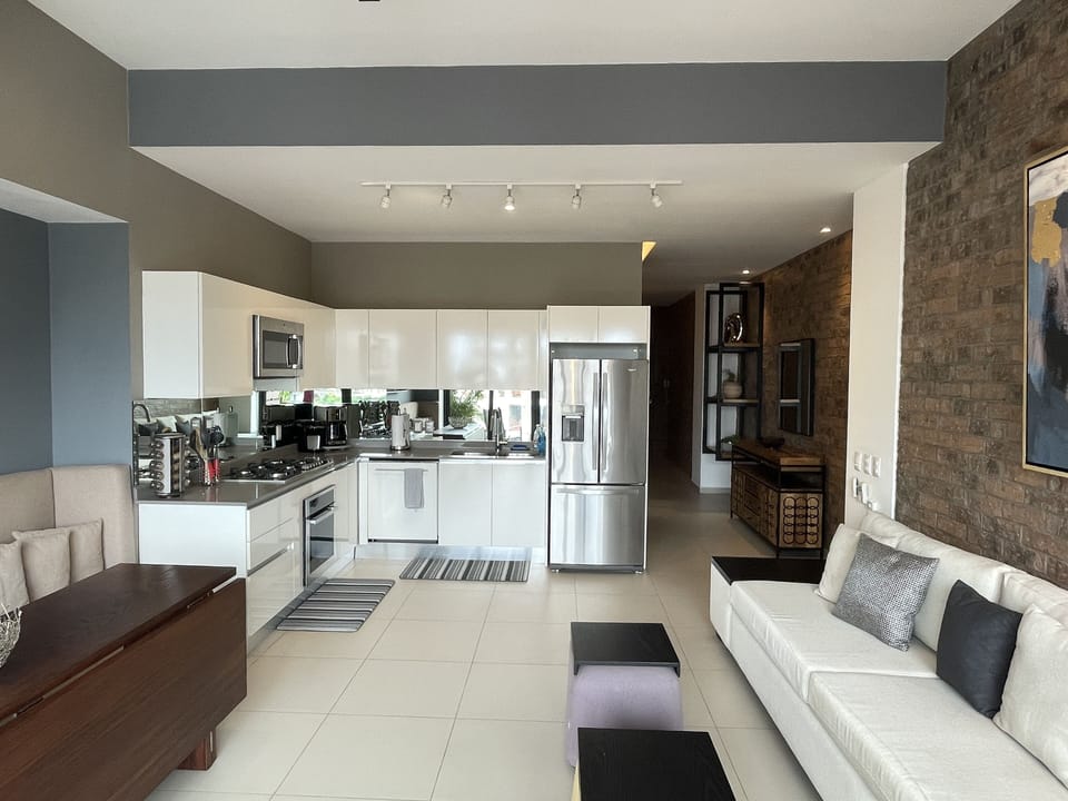 Spacious open floorplan with views to the balcony featuring city/ocean views