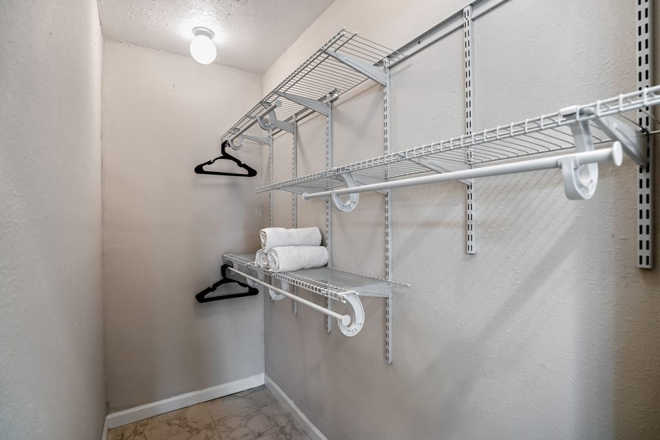 Primary bedroom walk-in closet