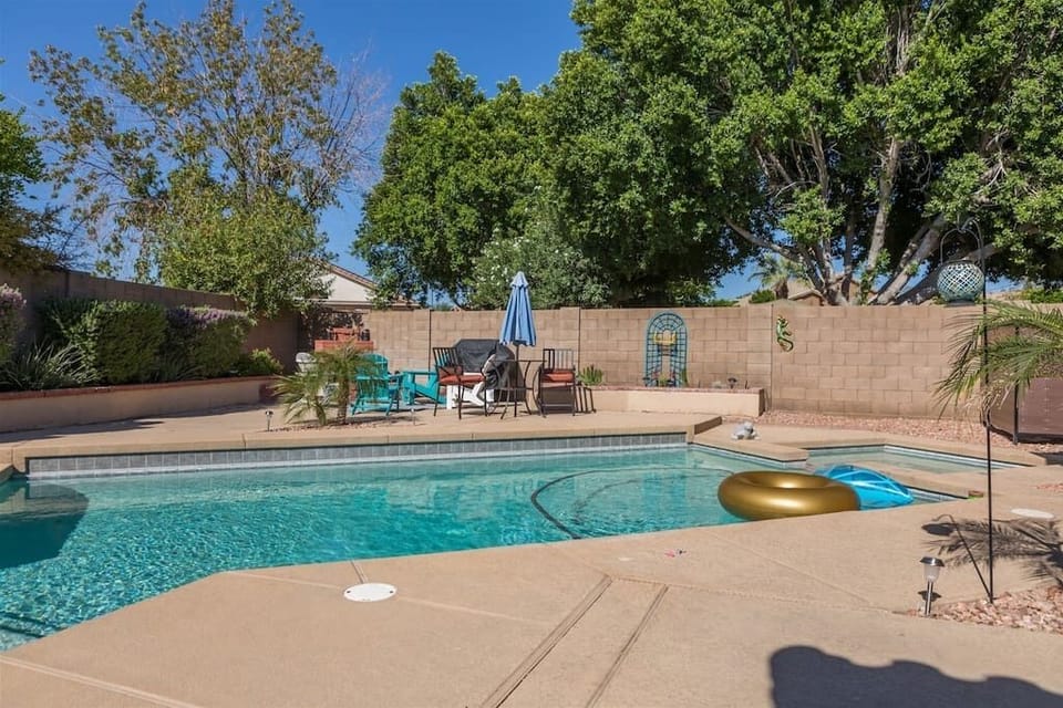 Large backyard area w/ patio seating, swimming pool and spa, and BBQ. Pool and spa heating optional,  fee required 