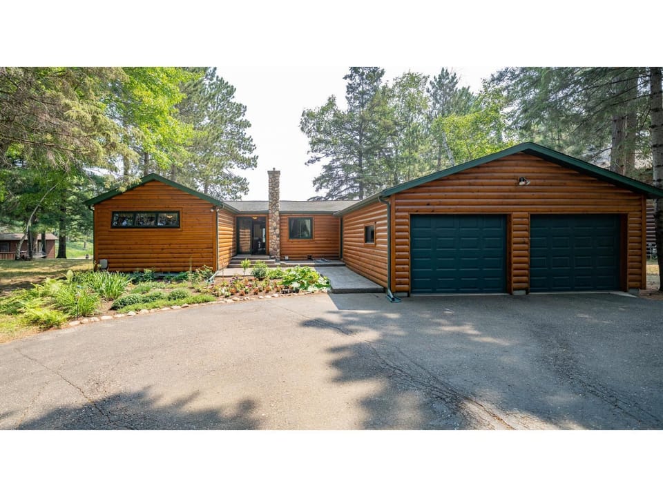 Front of main cabin.  Large front yard, circle driveway.  Attached 2 car garage.
