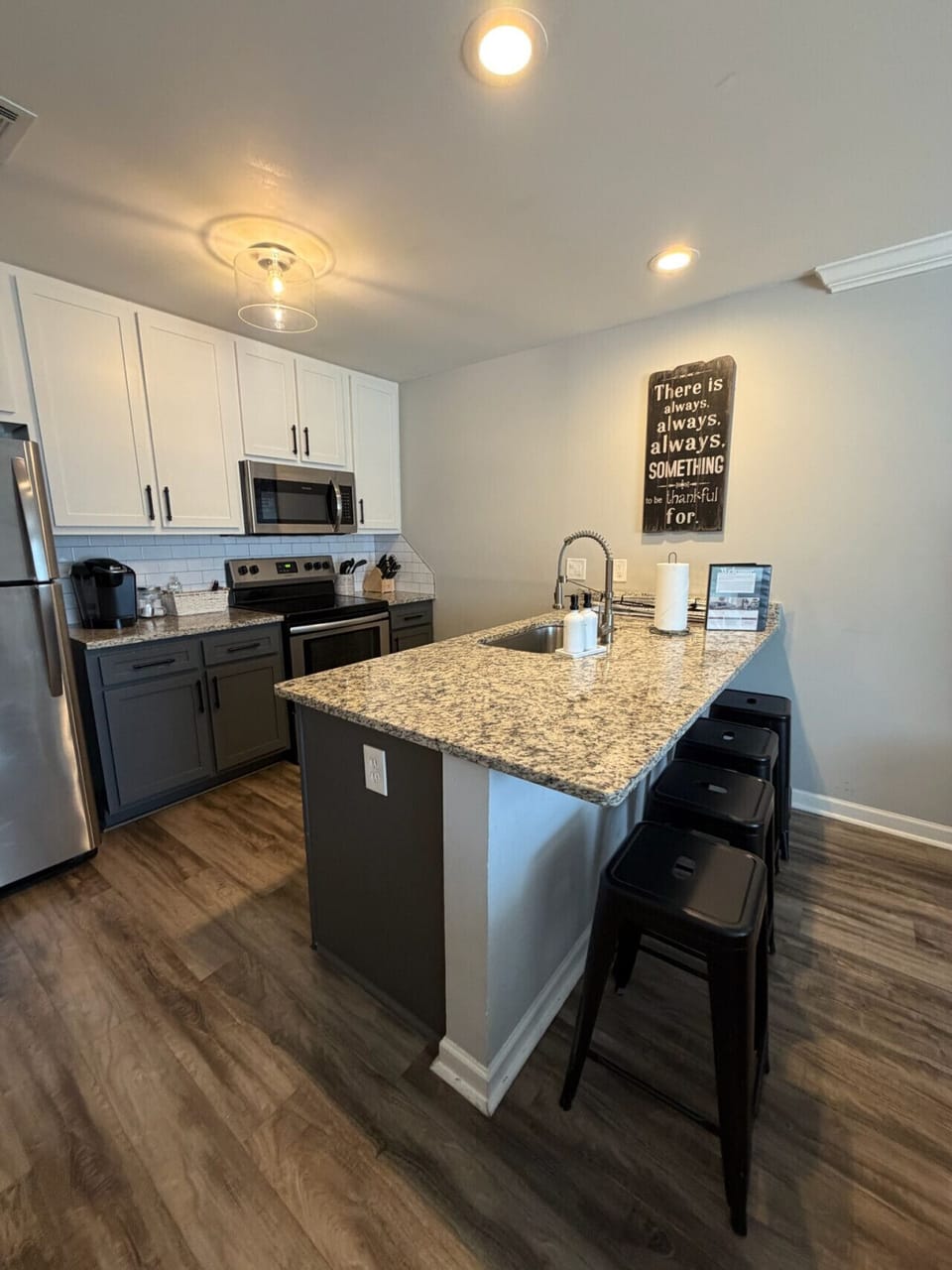 Modern kitchen with oversized island seating — perfect for meals, coffee, or gathering together.