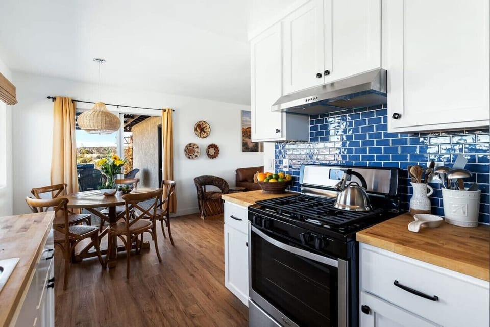 With earthy textures and sunlit charm, this kitchen and dining space invites you to gather, cook, and unwind in style.