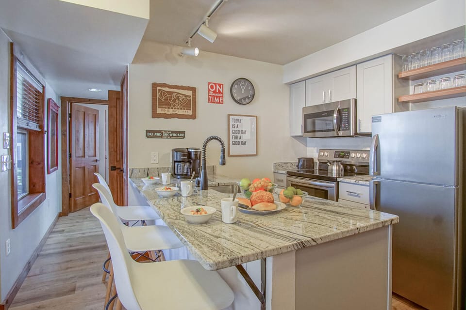Kitchen and kitchen counter with seating for three