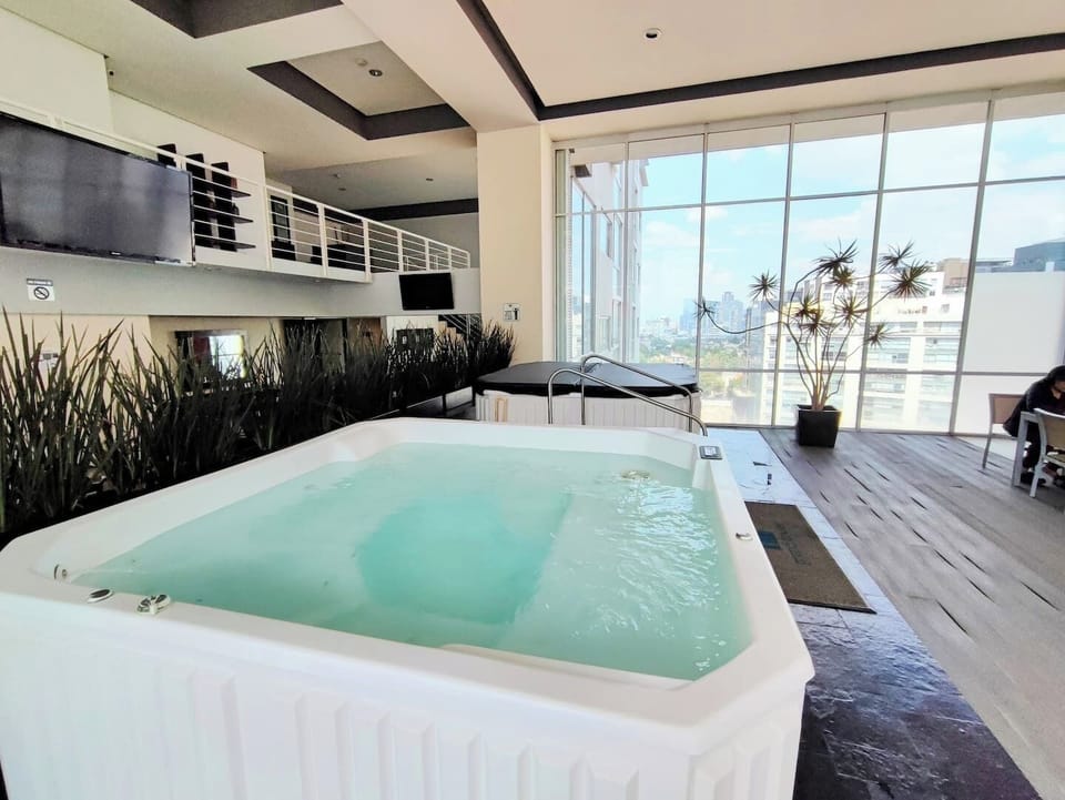 The jacuzzi area on the 16th floor is a tranquil oasis with stunning views. Relax and unwind in the warm bubbling waters, surrounded by a serene atmosphere, creating the perfect retreat for relaxation.