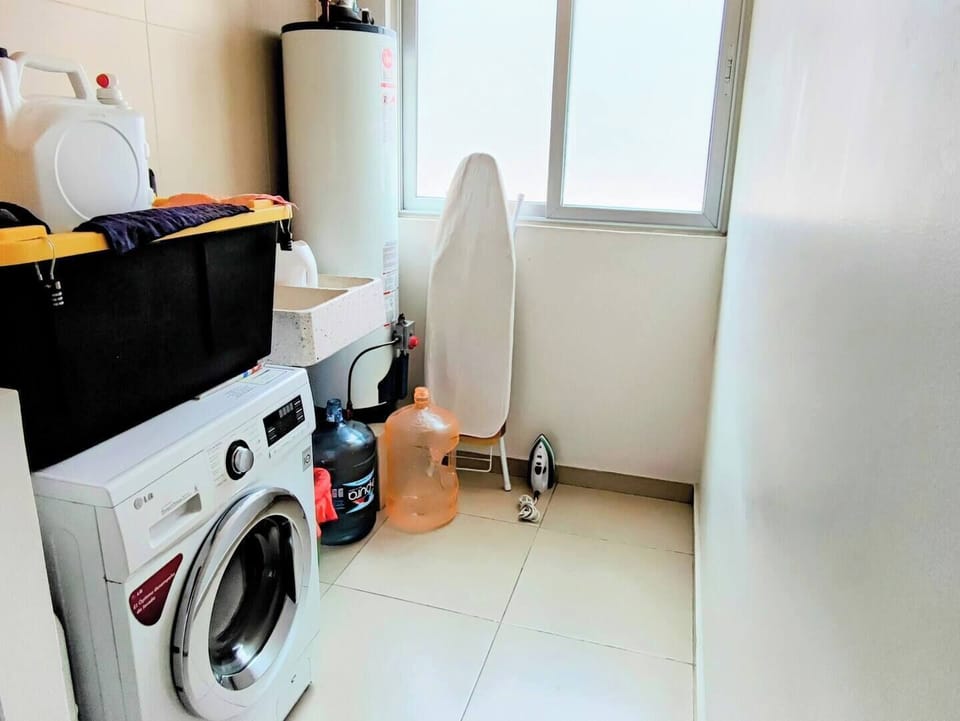 The apartment's laundry room is fully equipped with a washer and dryer, providing convenience and functionality for your laundry needs.