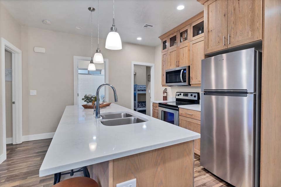 The downstairs kitchen is fully stocked with double ovens, fridge, stove, microwave oven, and dishwasher. There is plenty of seating on barstools at the island or at the dining table.