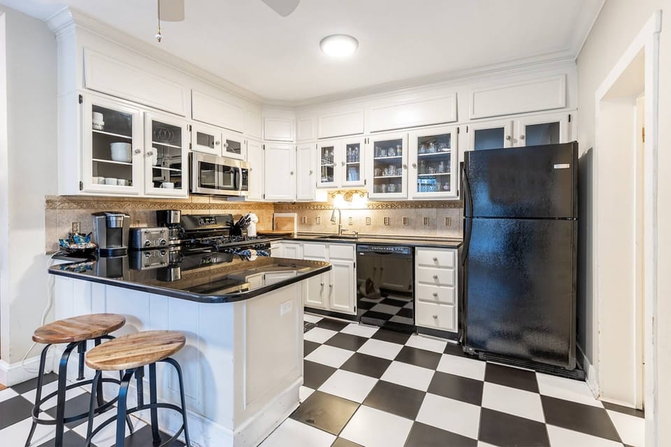 The charming kitchen is fully-stocked with cookware for you to make a family meal.