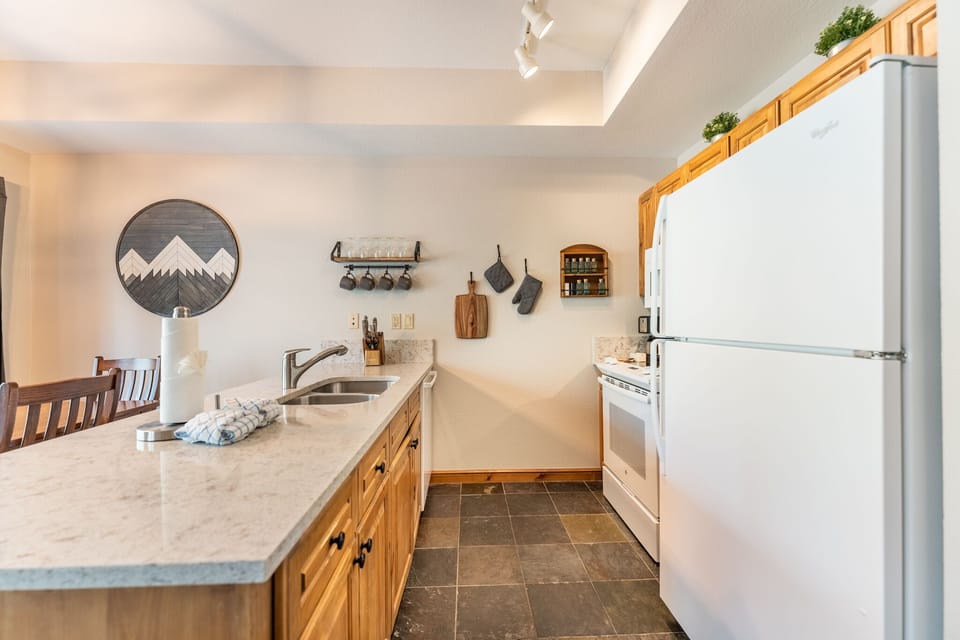 Your fully equipped kitchen features warm wood cabinets, granite counters, and everything you need to create memorable meals during your stay.