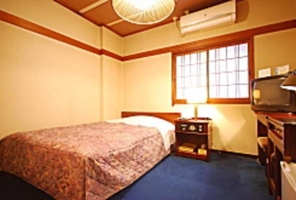 Desk, laptop workspace, bed sheets