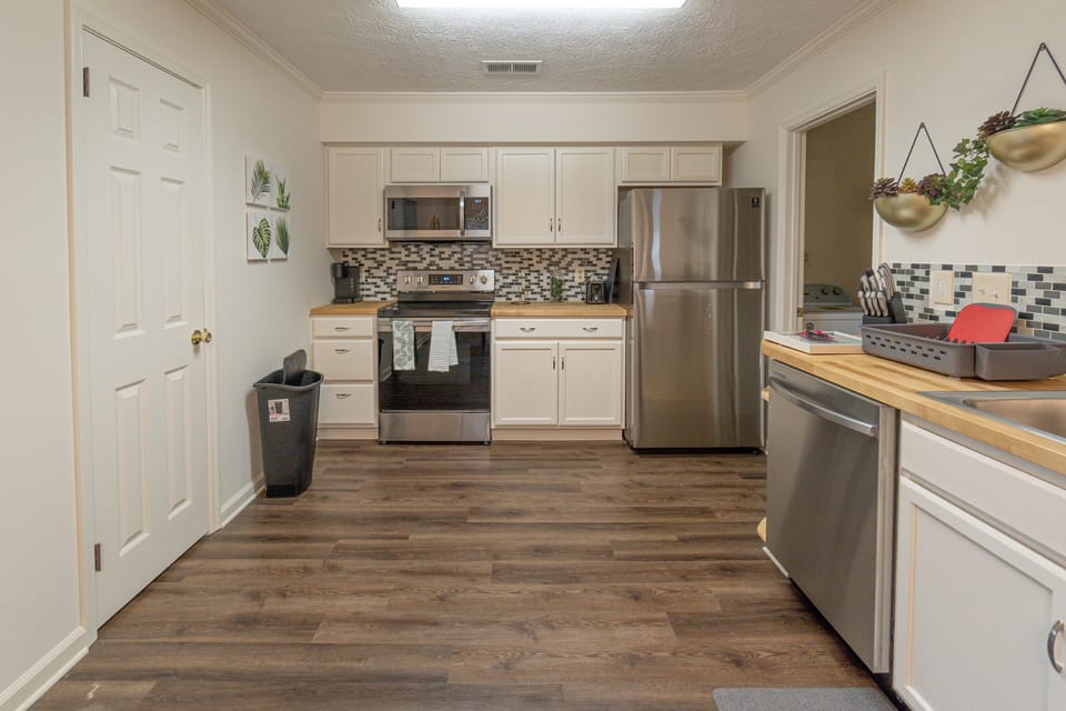 Modern stainless-steel appliances and stylish design define the kitchen