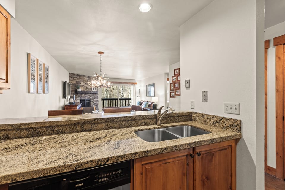 Prepare meals effortlessly in in the kitchen, overlooking the cozy living and dining areas.