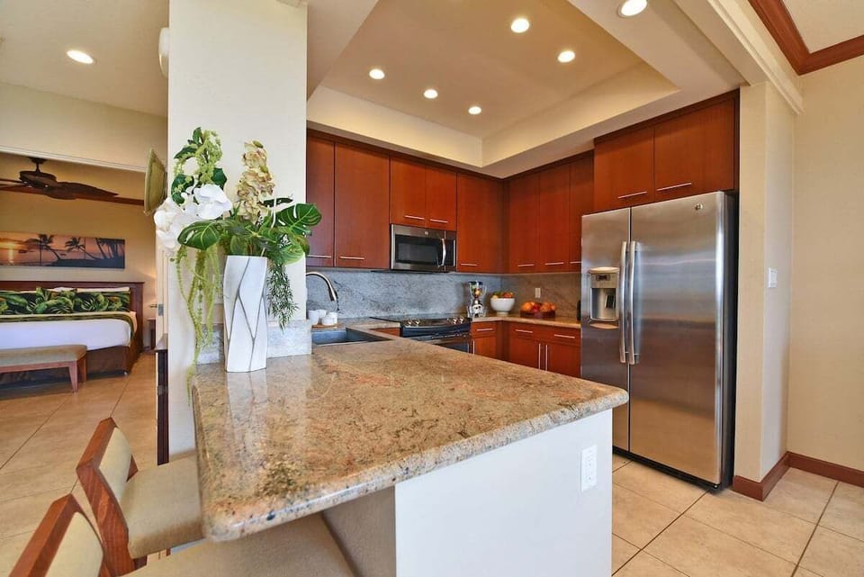 Fully equipped kitchen with stainless appliances and granite countertops.