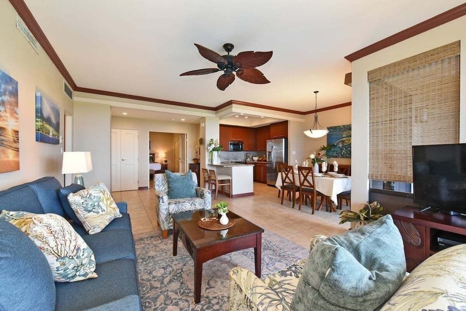Spacious open‑concept living area with natural light and tropical accents.