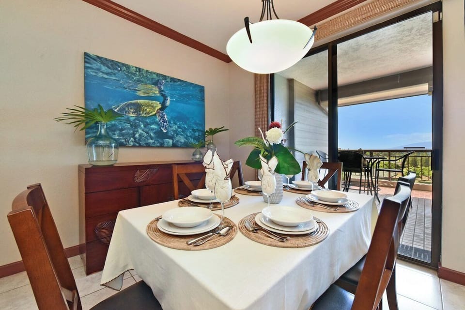 Dining table with lanai views, perfect for meals with a tropical backdrop.