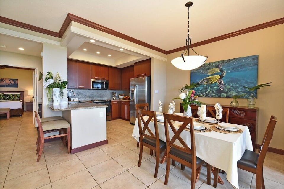 Dining area with seating for six and island‑inspired artwork.